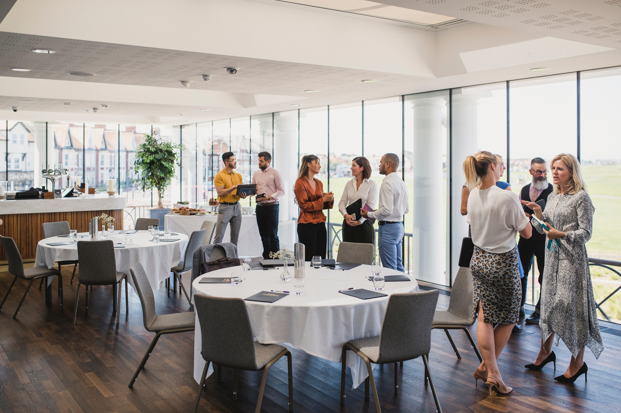 Colleagues talking and waiting for lunch at corporate event